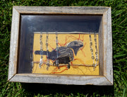 Mixed media sculpture in a wooden shadowbox frame of a bird sitting on a piece of twine with several red threads coming out from the bird. Rows of small plastic drawn rain drops hang along the top of the piece.