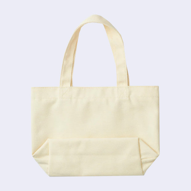 Backside of cream colored canvas tote bag, blank.