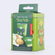 Green tin with floral illustrations on the side for making your own tea. Kit includes reusable tea bags, a spoon, cloth and bags.