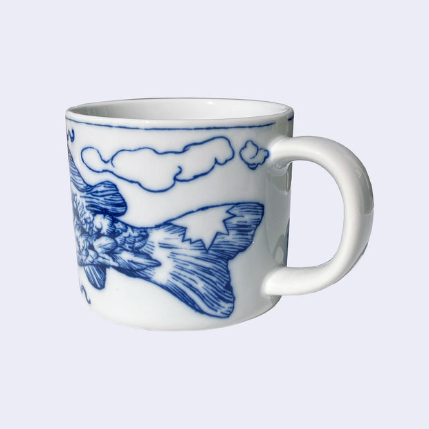 White porcelain mug with a dark blue line art illustration wrapped around it, with a large koi fish's tail.