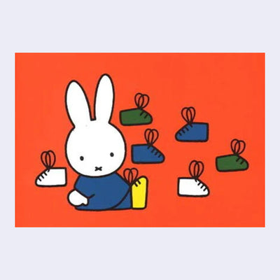 Reddish orange background for an illustration of Miffy, wearing a blue outfit and sitting on the ground wearing a yellow pair of shoes with looping laces. Several shoes with looping laces are behind.