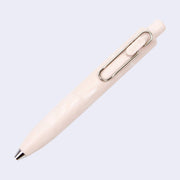 Thick, short light pink colored pen with marbled pattern and a side clip and a silver pen opening.