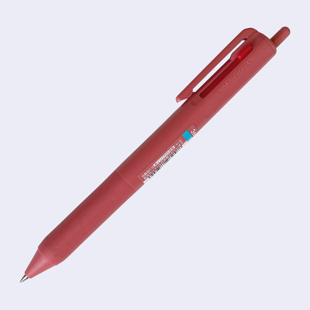 Berry pink ballpoint click pen with 3 ink colors: the main click is black, and 2 side sliding clicks are blue and red.