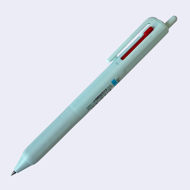 Ice blue ballpoint click pen with 3 ink colors: the main click is black, and 2 side sliding clicks are blue and red.