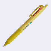 Mustard yellow ballpoint click pen with 3 ink colors: the main click is black, and 2 side sliding clicks are blue and red.