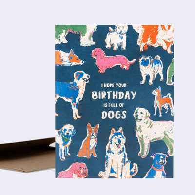 Greeting card, a navy blue with illustrations of many cololrful dogs, standing or sitting in relaxed manners with text in the center that reads "I Hope Your Birthday is Full of Dogs".