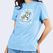 Front view of model wearing a light blue t-shirt. On chest area is a drawing of Gudetama riding a Mermicorno surrounded by a heart shaped bubble.