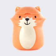 Plastic figure of a smiling orange cartoon fox with a happy face and a cream colored under body. Its head can be lifted up and floss can go inside.