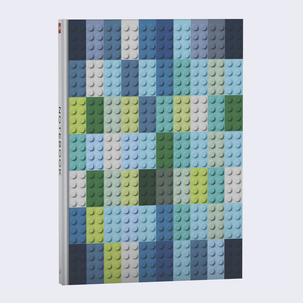 Notebook with a textured cover and design that looks like 70 legos (7 rows, 10 columns) stacked next to one another. All Legos are in a cool color scheme: blues, greens and white.