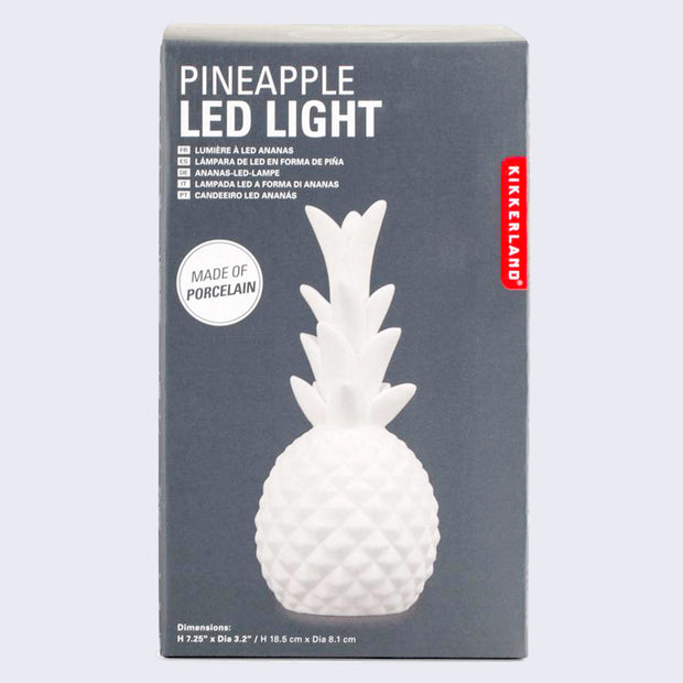 Product packaging for Pineapple LED Light, dark gray with the specs written in white ink and a photo of the white porcelain lamp in the shape of a pineapple.