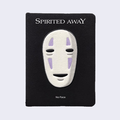 Black plush surface journal, with an embroidery of No Face's head in the center. "Spirited Away" is written on the plastic cover, with "No Face" written below.