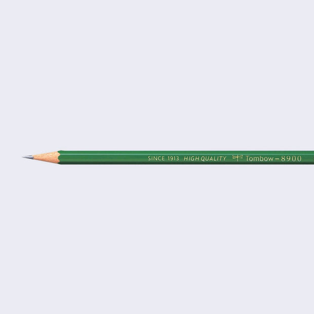 A sharpened Tombow brand pencil with a forest green body.