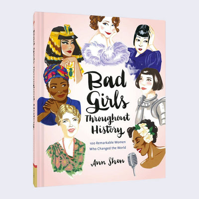 Pink hardbound book cover with illustrations of various women in a circle, all framing cursive black text that reads "Bad Girls Throughout History"