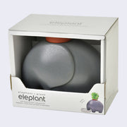 A smooth, gray ceramic modern looking elephant with a pot on its head, encased in a white cardboard box that reads "elephant + plant Eleplant" on it with product description.