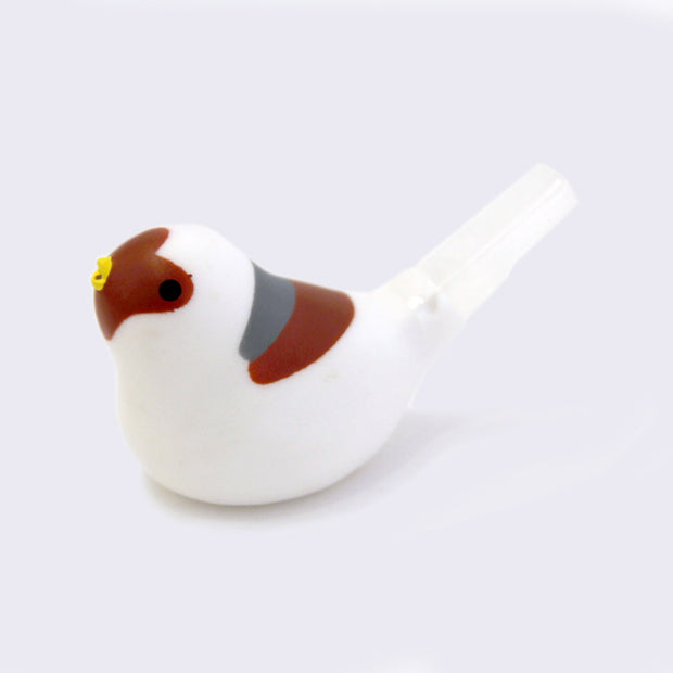 White plastic bird with brown and gray color accents and its tail is a whistle.