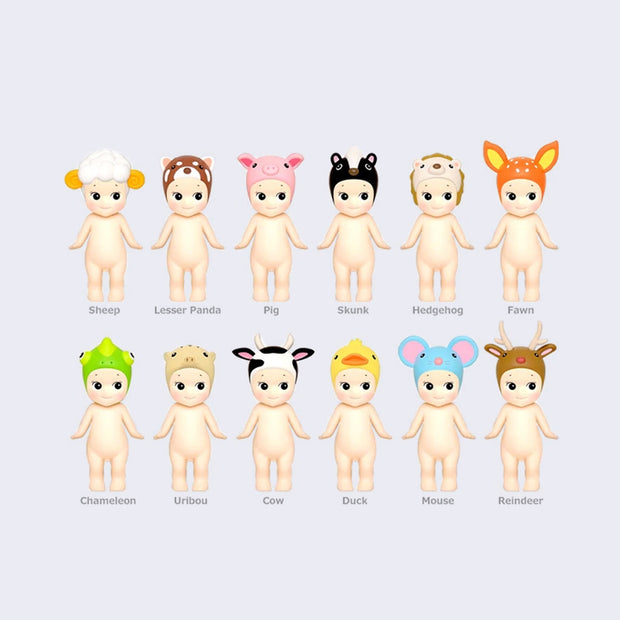 12 vinyl Kewpie babies, standing nude with different animal themed hood hats. Options are: sheep, red panda, pig, skunk, hedgehog, fawn, chameleon, tapir, cow, duck, mouse and reindeer.