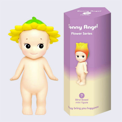 Vinyl Kewpie baby figure, standing nude while wearing a sunflower on its head. Beside is its display box, purple to cream ombre with a small Kewpie baby wearing a tulip hat.